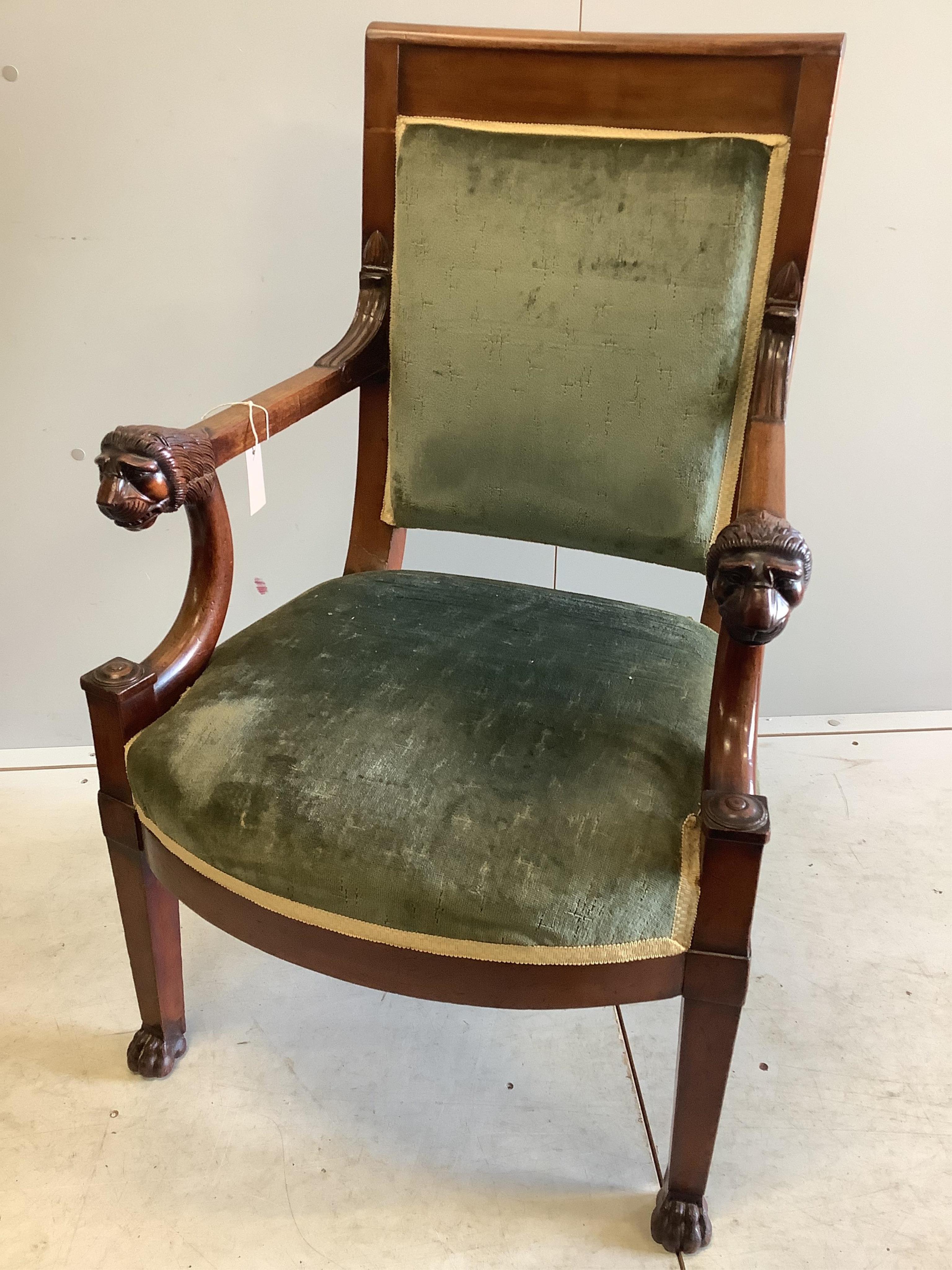 A 19th century French Empire mahogany fauteuil with carved lion's heads arms, once owned by Bernard Levin, with a letter of provenance, width 59cm, depth 49cm, height 96cm. Condition - fair